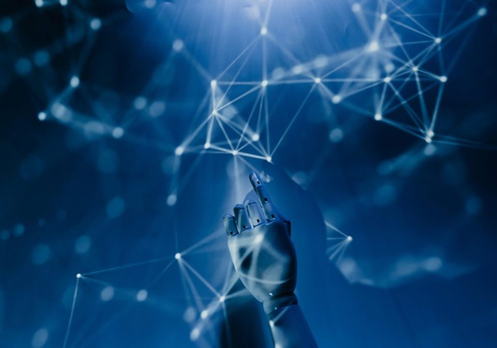 AI-Demystified_-What-to-Know-About-the-Current-Tools-on-the-Market-in-2025-scaled.jpg Free A robotic hand reaching into a digital network on a blue background, symbolizing AI technology. Stock Photo